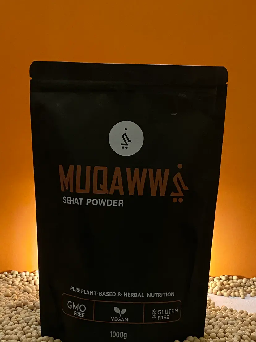 Muqawwi Sehat Powder pouch glowing against a warm orange backdrop